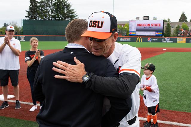 Morgan Pearson hugging baseball coach Pat Casey on Goss Stadium field.