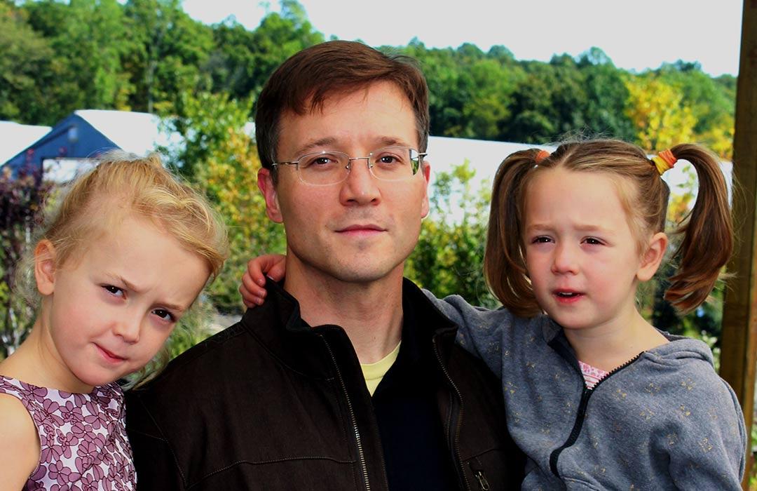Justin Hall with his daughters in park
