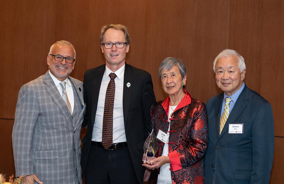 John Donnelly and Roy Haggerty giving award to Edward and Janet Chen