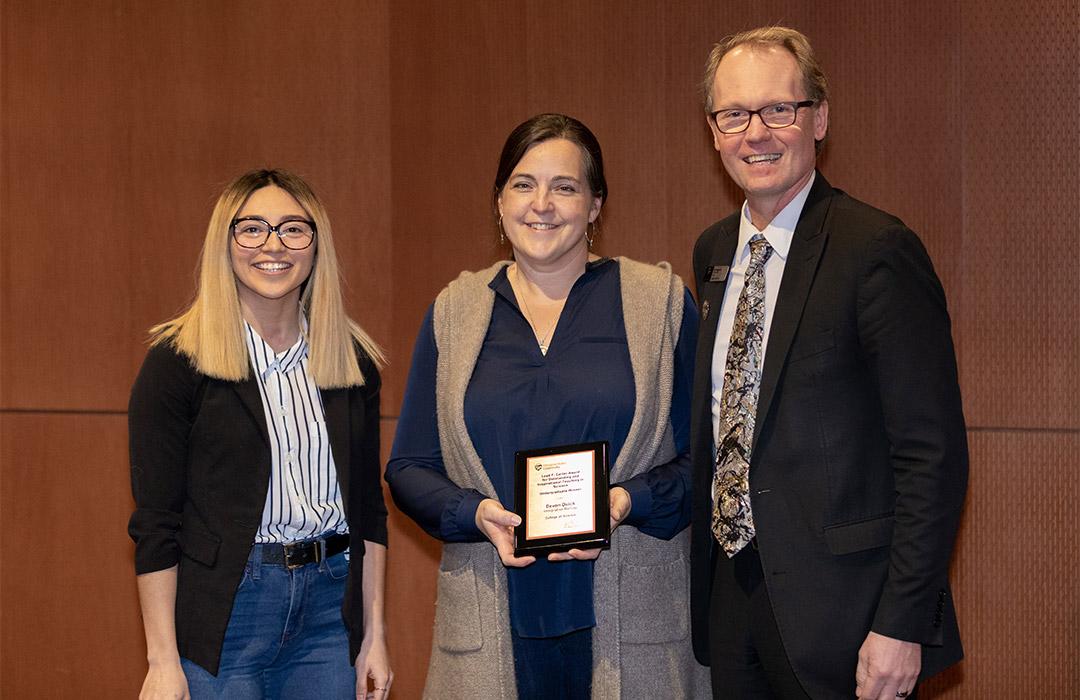 Devon Quick poses with award with microbiology student Arisa Larmay (left) and Dean Haggerty (right)