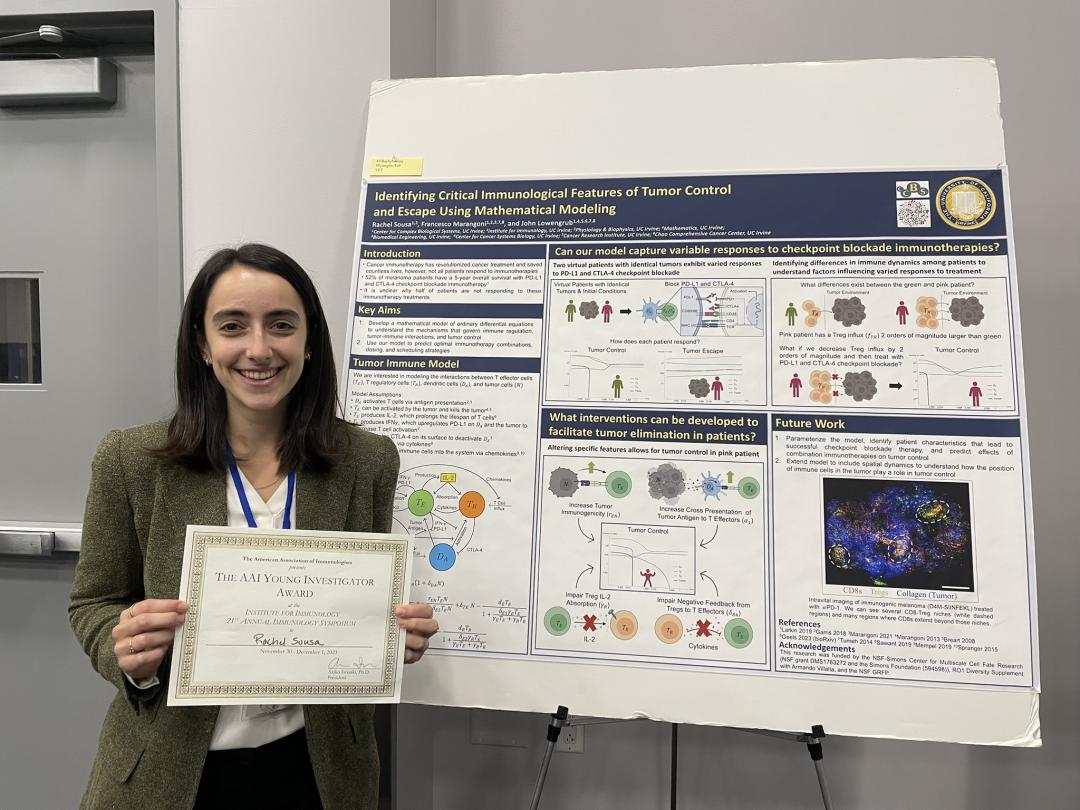 Sousa holds up a certificate for the American Association of Immunologists Young Investigator Award while standing in front of her research poster.