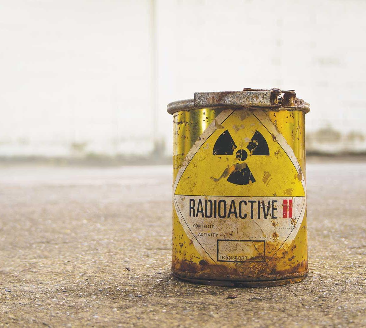 Radioactive waste bucket in concrete backdrop