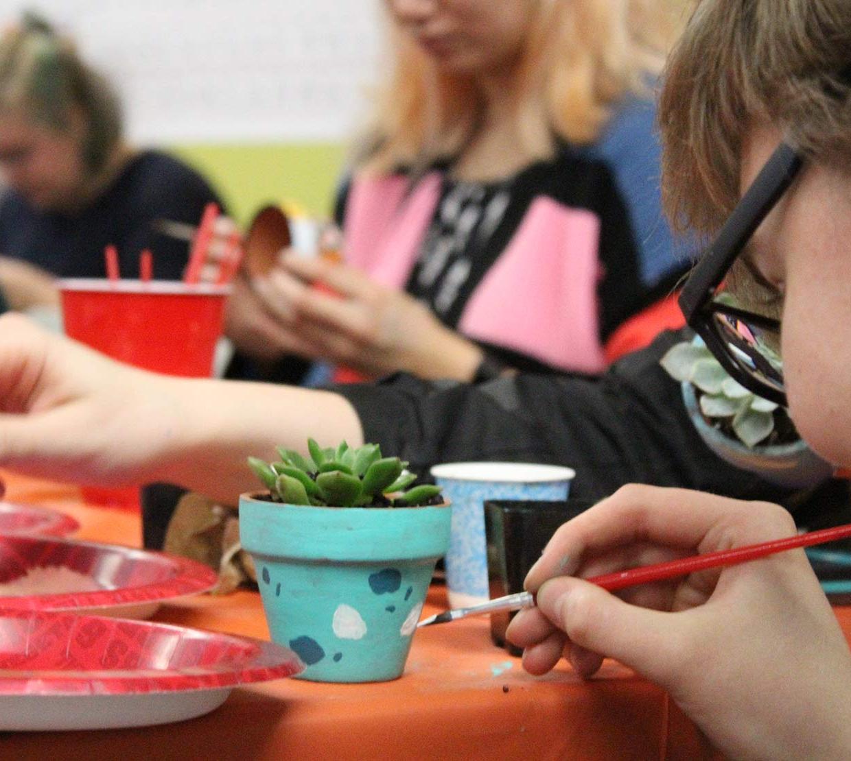 children painting succulent pots