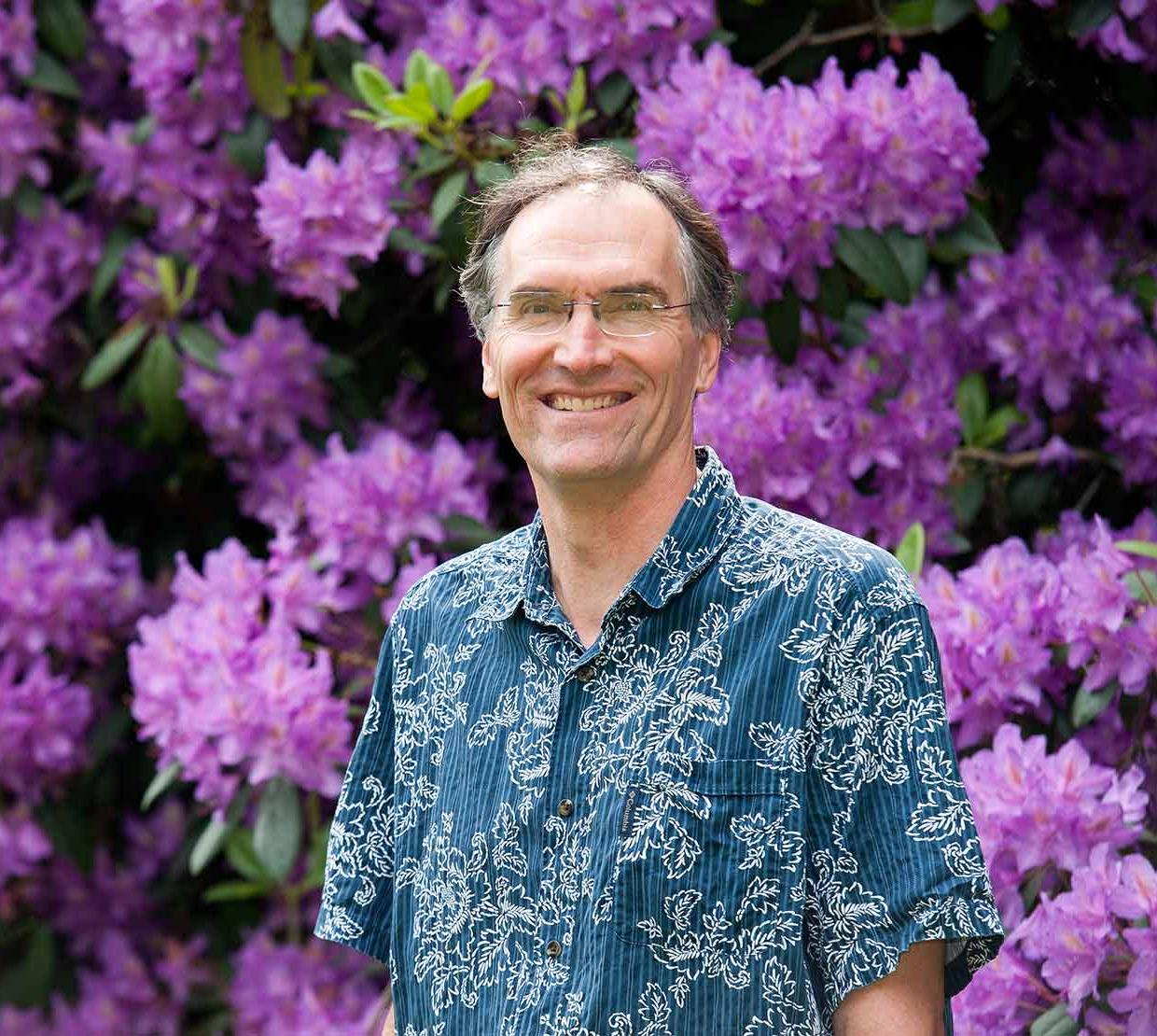 David McIntyre in front of purple bush