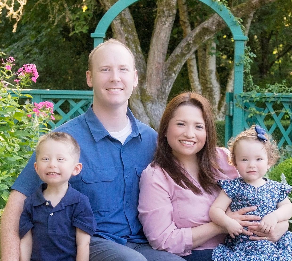 Drs. Luisa and Nathan Snyder with their children in garden