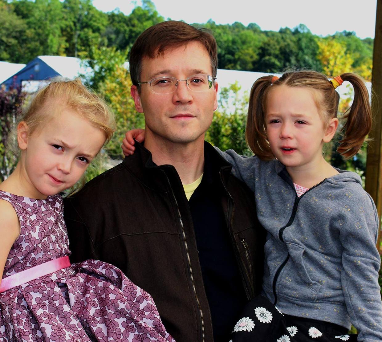 Justin Hall with his daughters in park