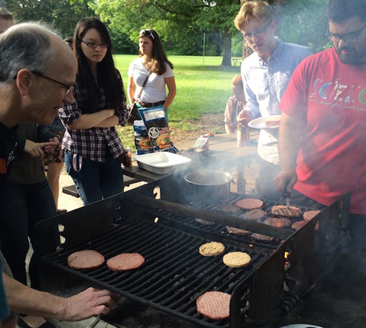 Andy Karplus and students grilling burgers in park