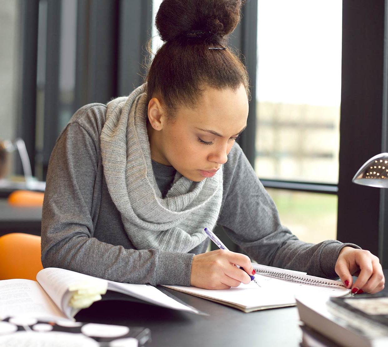 Woman working on homework at table
