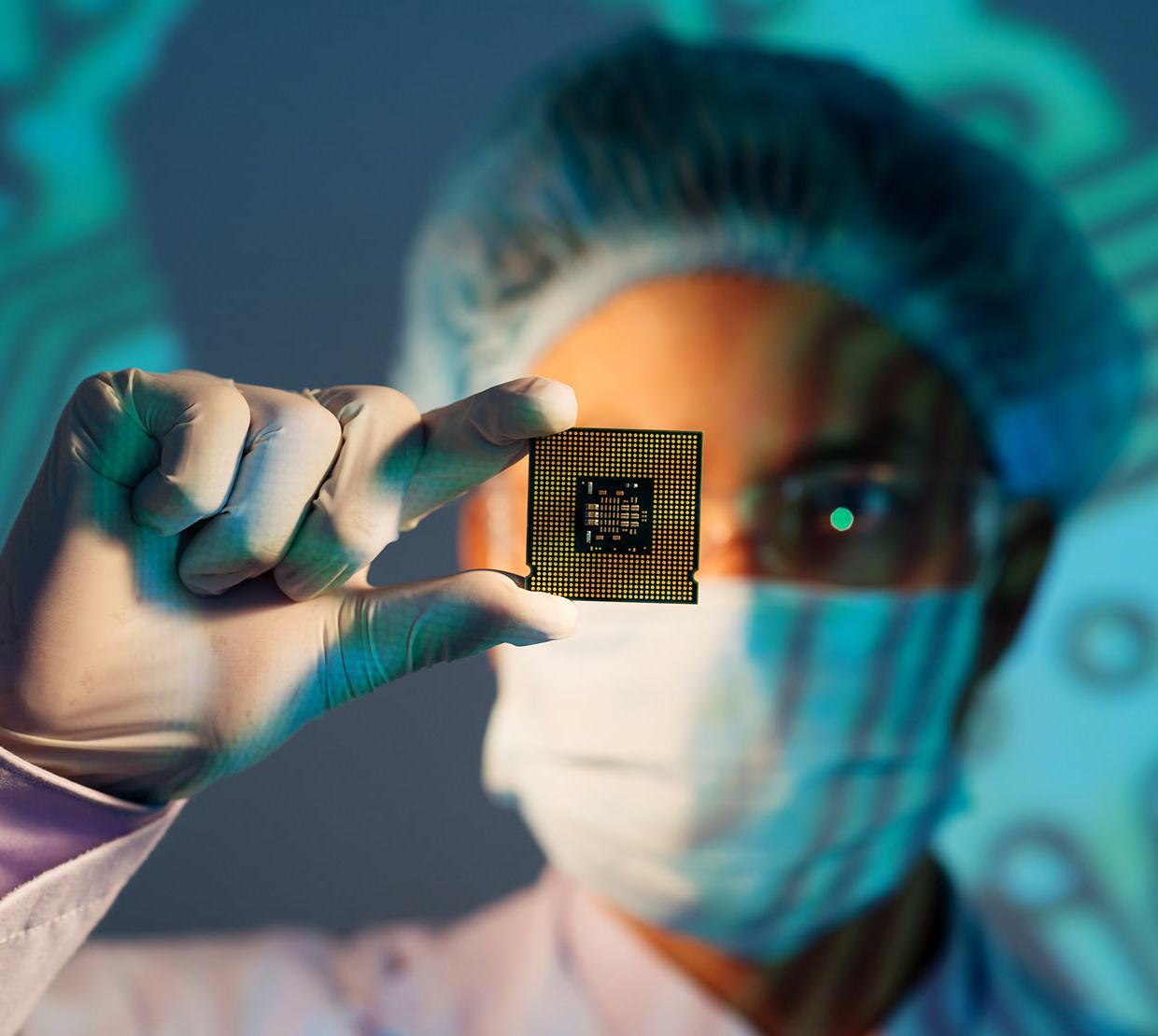 Scientist holding microchip in lab