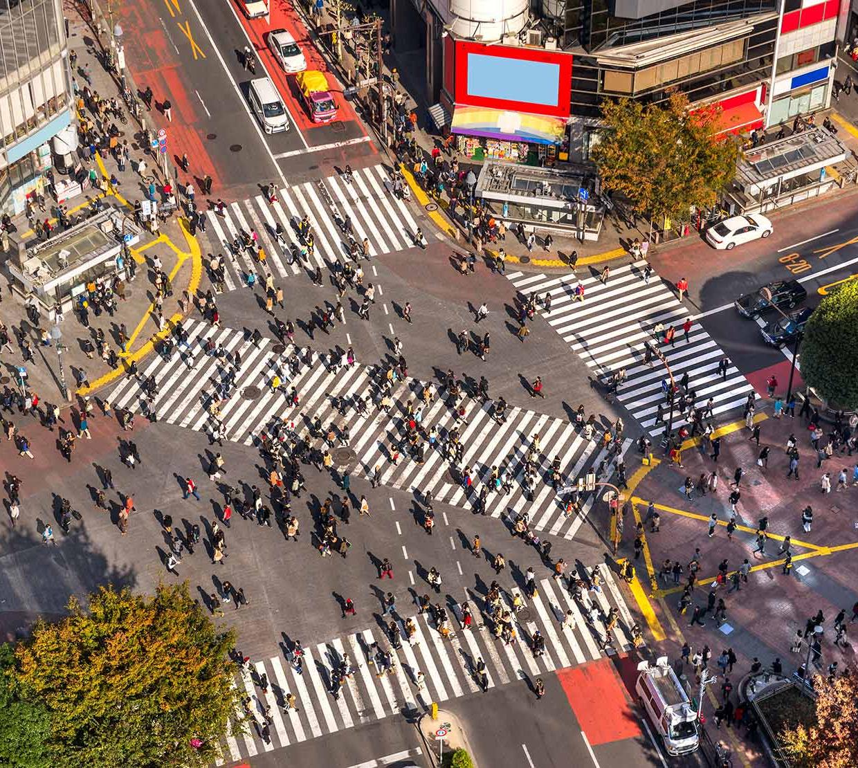 arial view of citizens walking through busy intersection in Japan