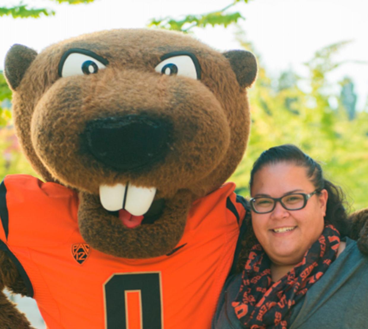 College of Science Head Advisor Heather Arbuckle smiling with Benny Beaver