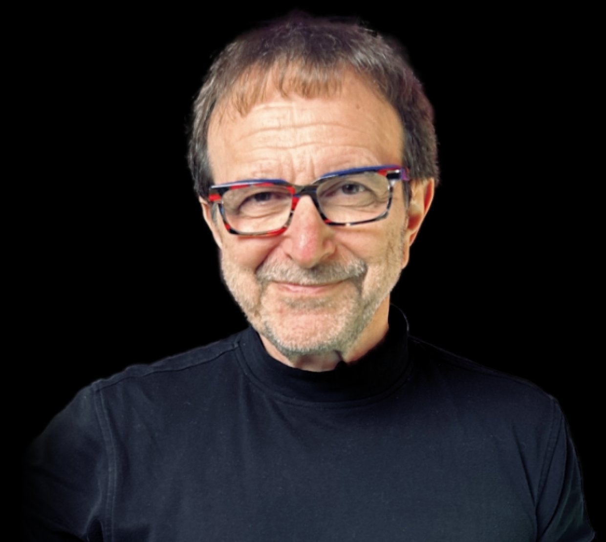 Vincent Racaniello wears a black shirt on a black background. He smiles slyly.