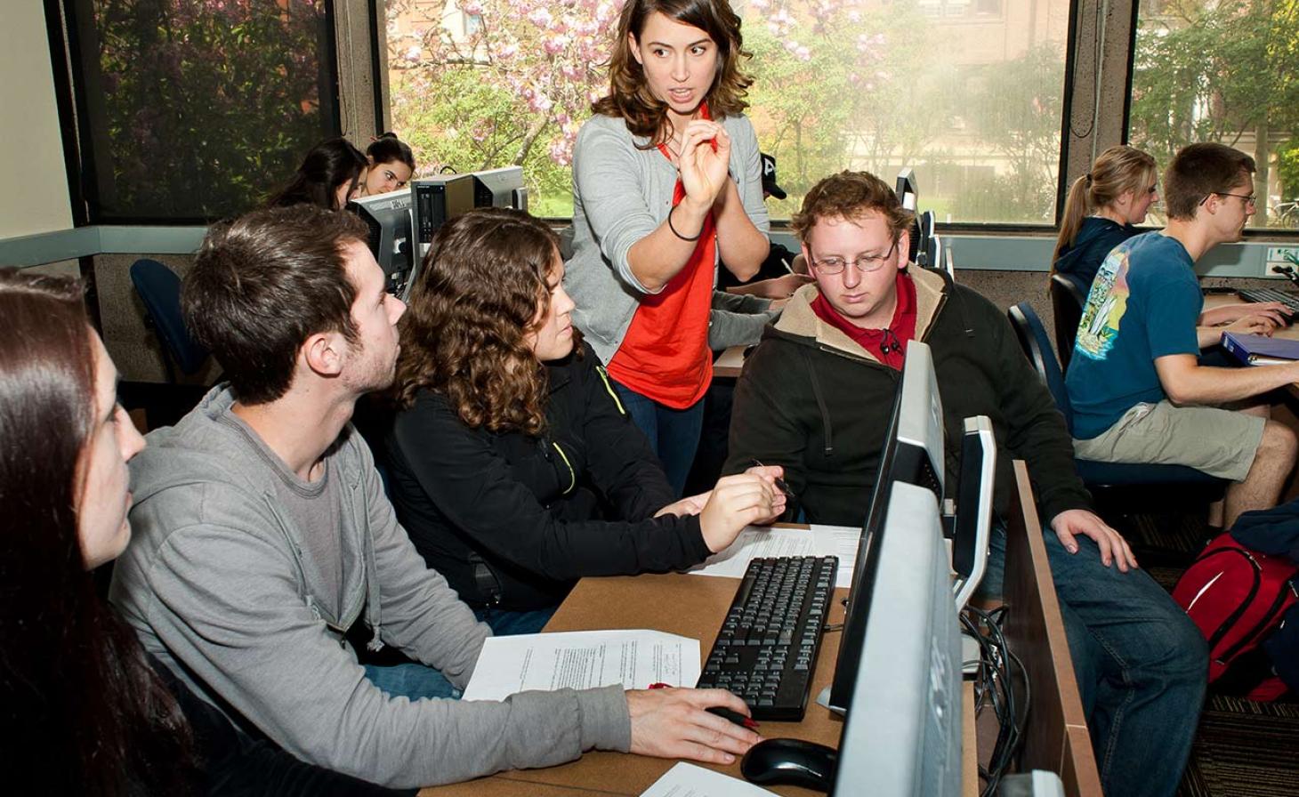 professor helping students in computer lab