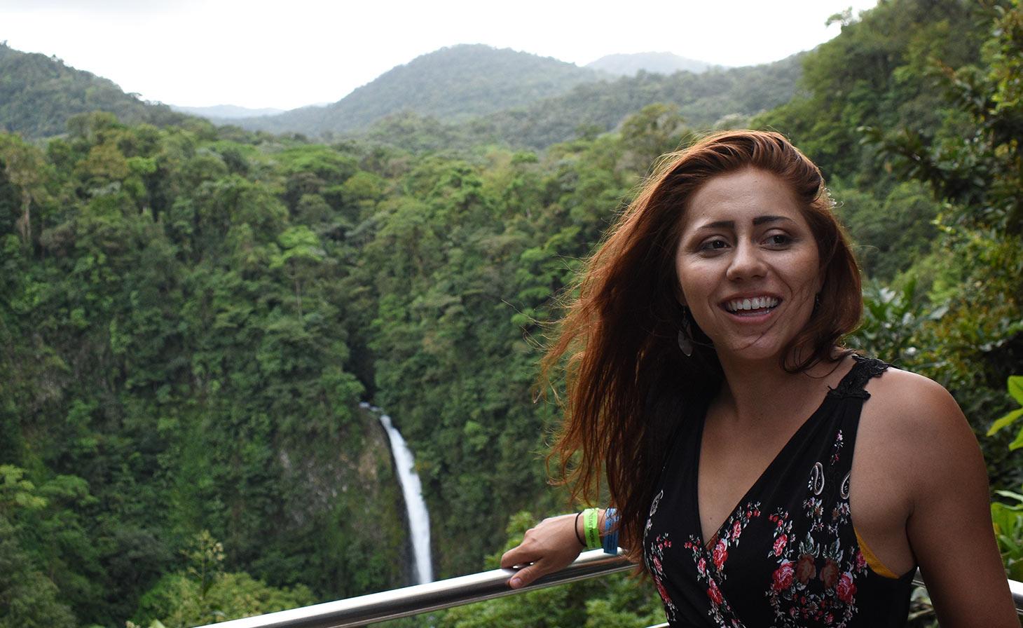 Tonya Allison in front of waterfall in tropical forest