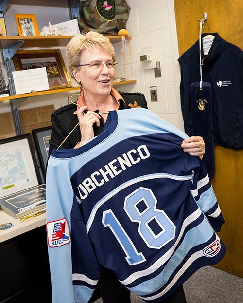 Jane Lubchenco holds up a blue and white hockey jersey with her last name emblazoned on the back. A gift from a local youth hockey team excited for the scientist's visit to their hometown.
