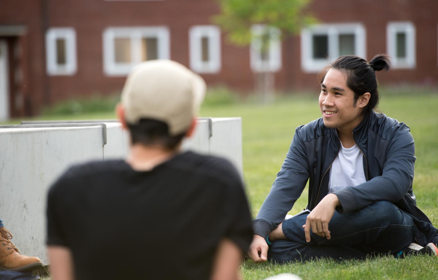 students sitting on Austin Hall lawn