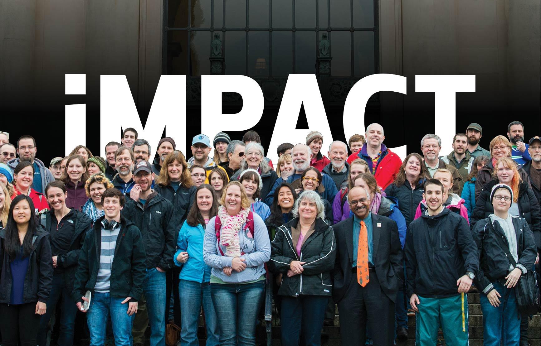 IMPACT title behind group photo of staff and faculty on Memorial Union steps