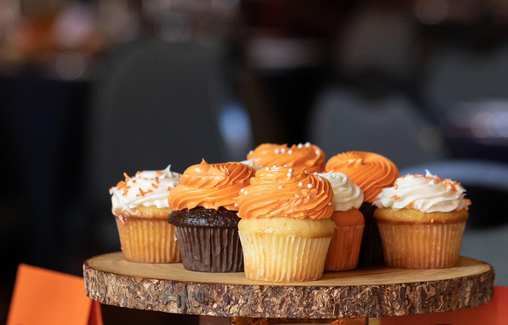 Orange and white cupcakes served at an OSU event.