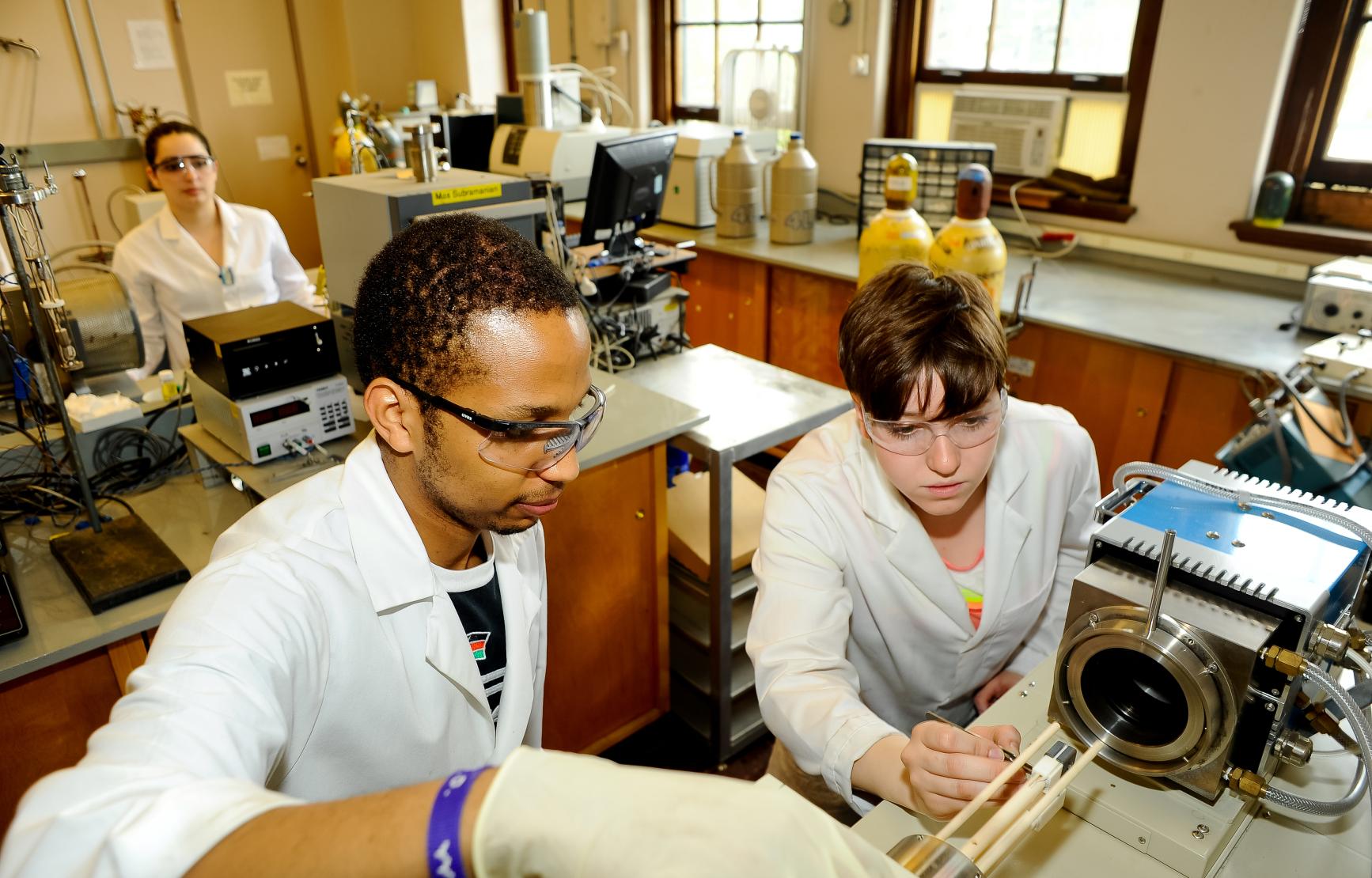 Two students working in the Mas Subramanian Chemistry lab.