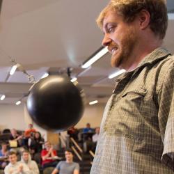 KC Walsh giving using bowling ball in lecture demo