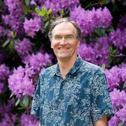 David McIntyre in front of purple bush