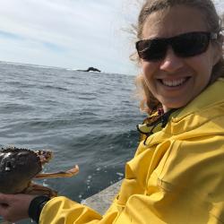Sarah Henkel holding crab on ocean