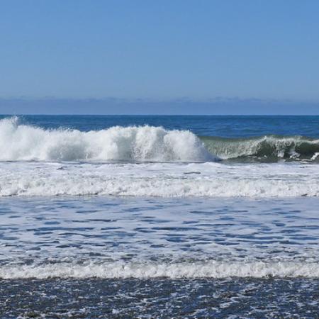 Waves crashing against the sand