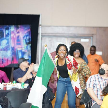 Ebunoluwa Morakinyo is seen dancing with an Nigerian flag during African night.