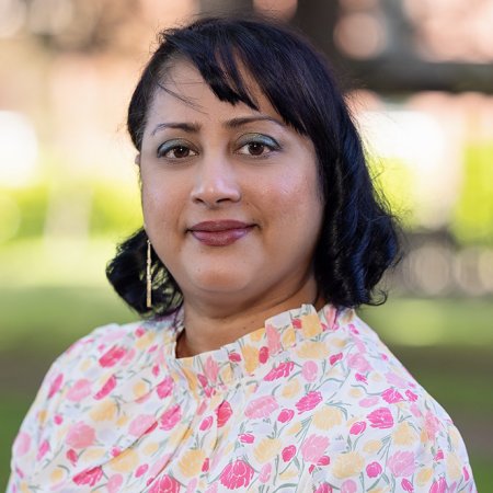 Marilyn wears a brightly colored shirt and smiles on OSU campus