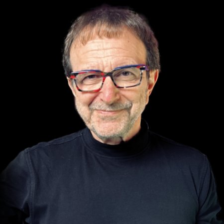 Vincent Racaniello wears a black shirt on a black background. He smiles slyly.