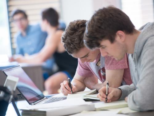 Two students studying together in classroom