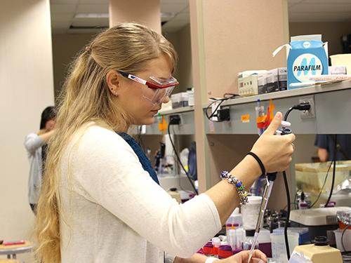 female student working with samples in lab