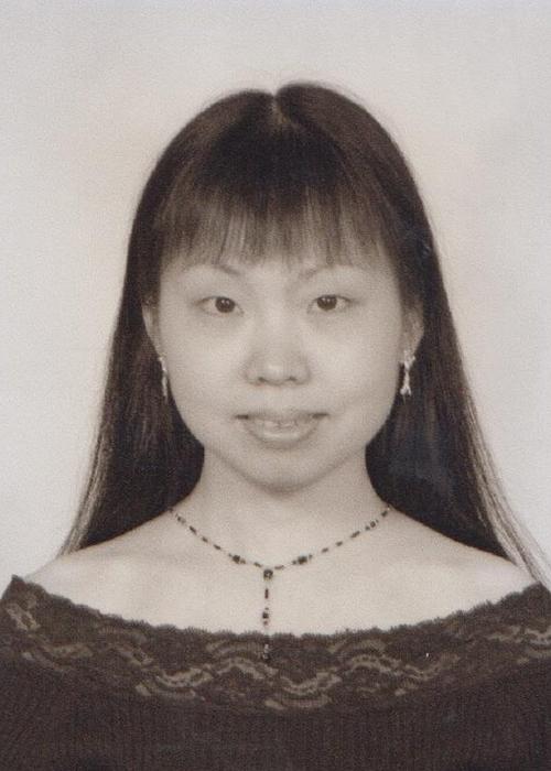 black and white photo of Jun Li in front of white backdrop