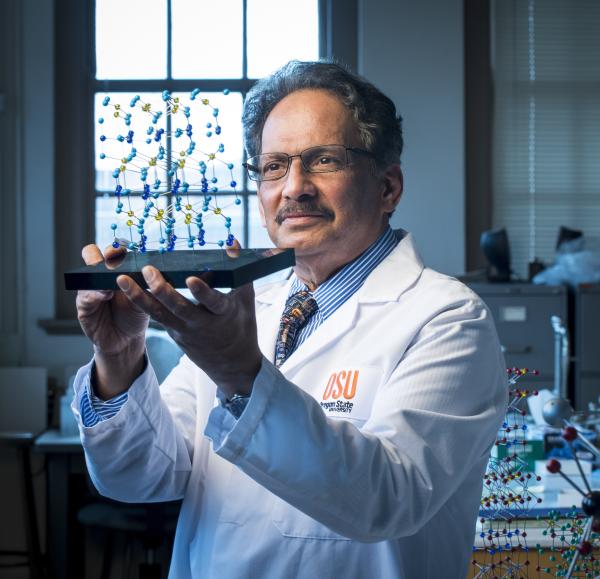 Picture of Professor Mas Subramanian with a Molecular Model of YInMn Blue