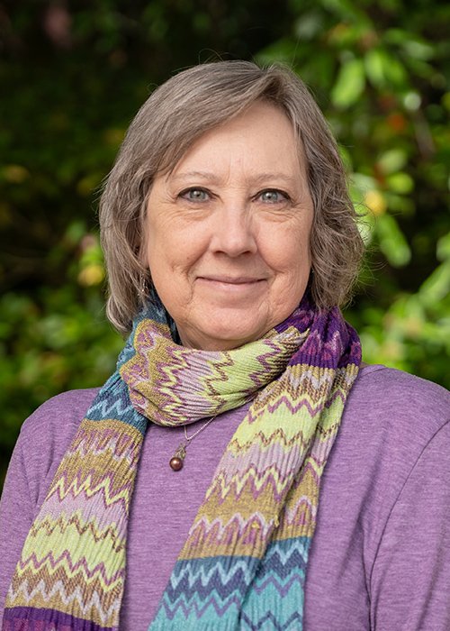 Smiling headshot of Bettye in a colorful scarf