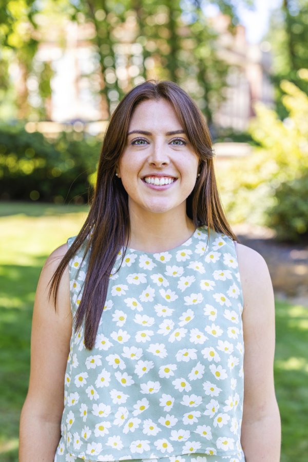 A photo of Rachel Palmer who has long brown hair, green eyes, and is smiling