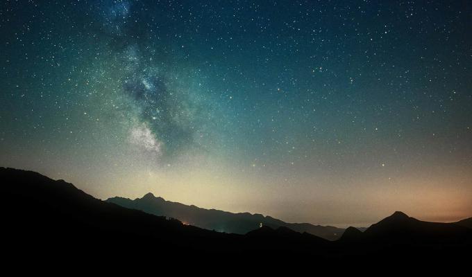 Starry time-lapse over mountain range