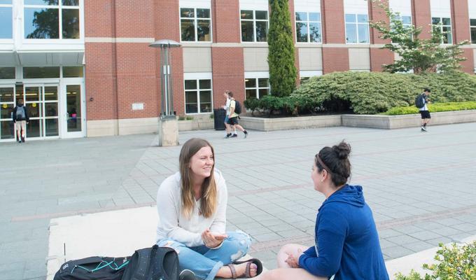 female students sitting in front Valley Library