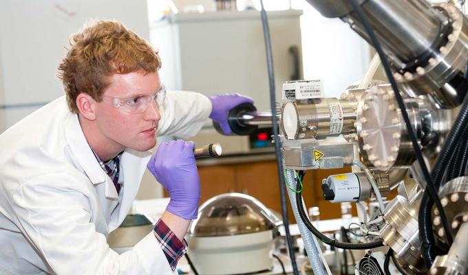 student working with machinery in lab