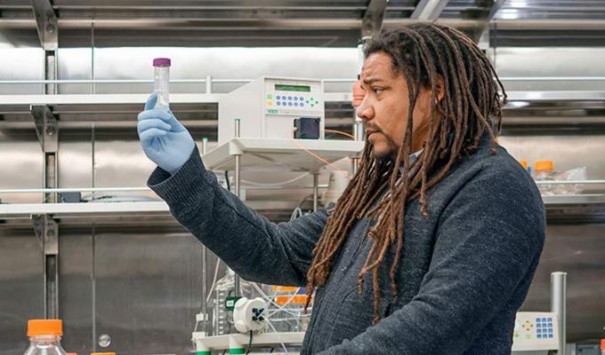 Bil Clemons analyzing test tubes in lab