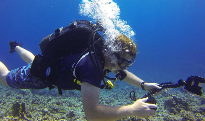 Ryan McMinds scuba diving on shallow seafloor