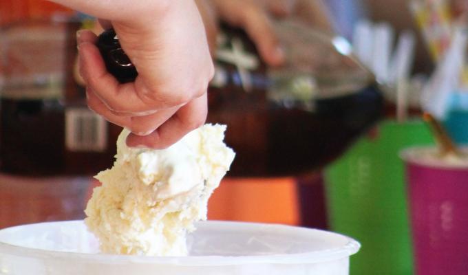 Hand scooping ice cream