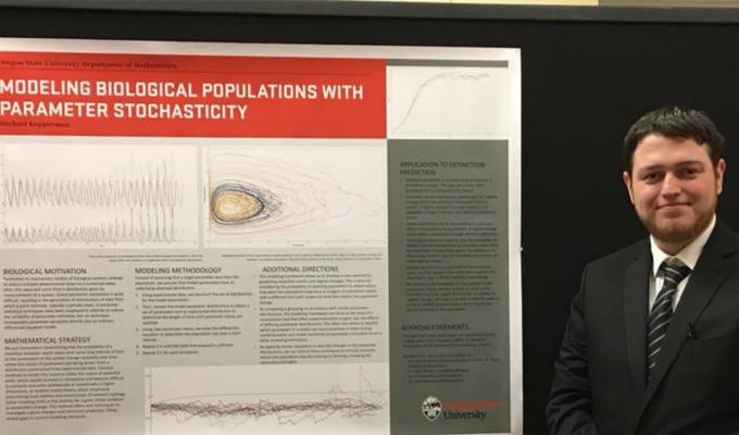 Michael Kupperman in front of his research poster
