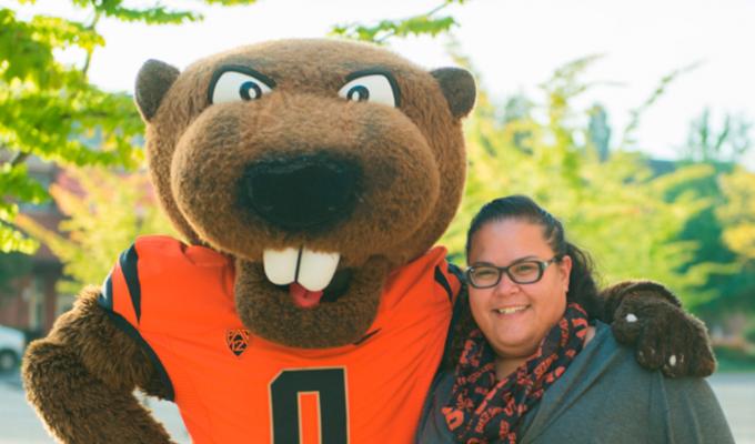College of Science Head Advisor Heather Arbuckle smiling with Benny Beaver