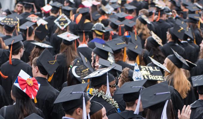 a group of people wearing graduation cap and gowns