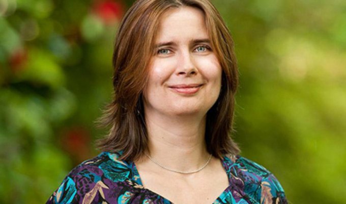 Oksana Ostroverkhova smiling on campus in spring