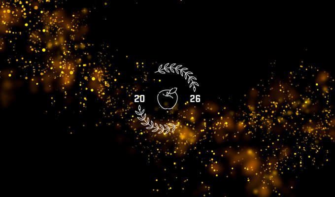 A black background with orange glitter, an apple and the year 2026.