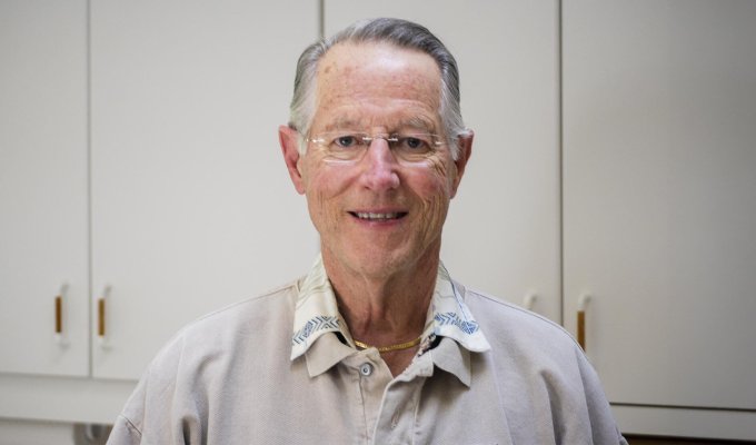 A man in grey shirt poses for photo.
