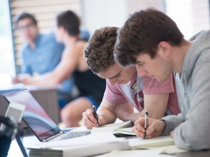 Two students studying together in classroom