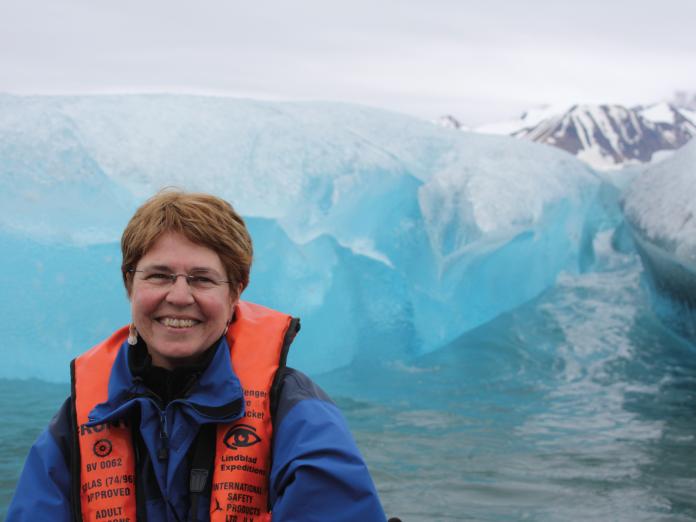Jane Lubchenco standing in front of Arctic glaciers near Svalbard